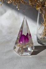 Load image into Gallery viewer, Crystal prism with a purple flower inside, surrounded by dried plants on a neutral background
